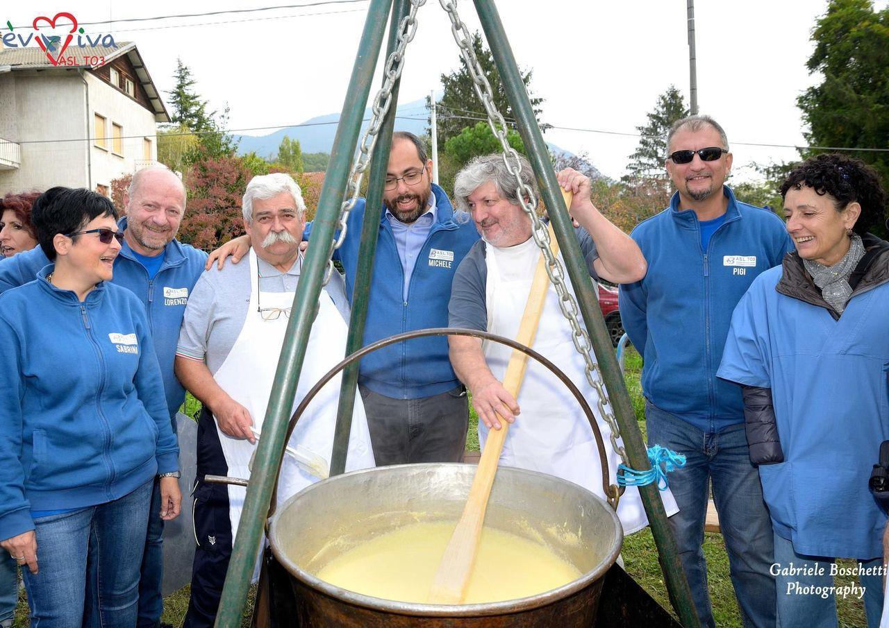 Volunteers cooking polenta for the community at a town-square festival